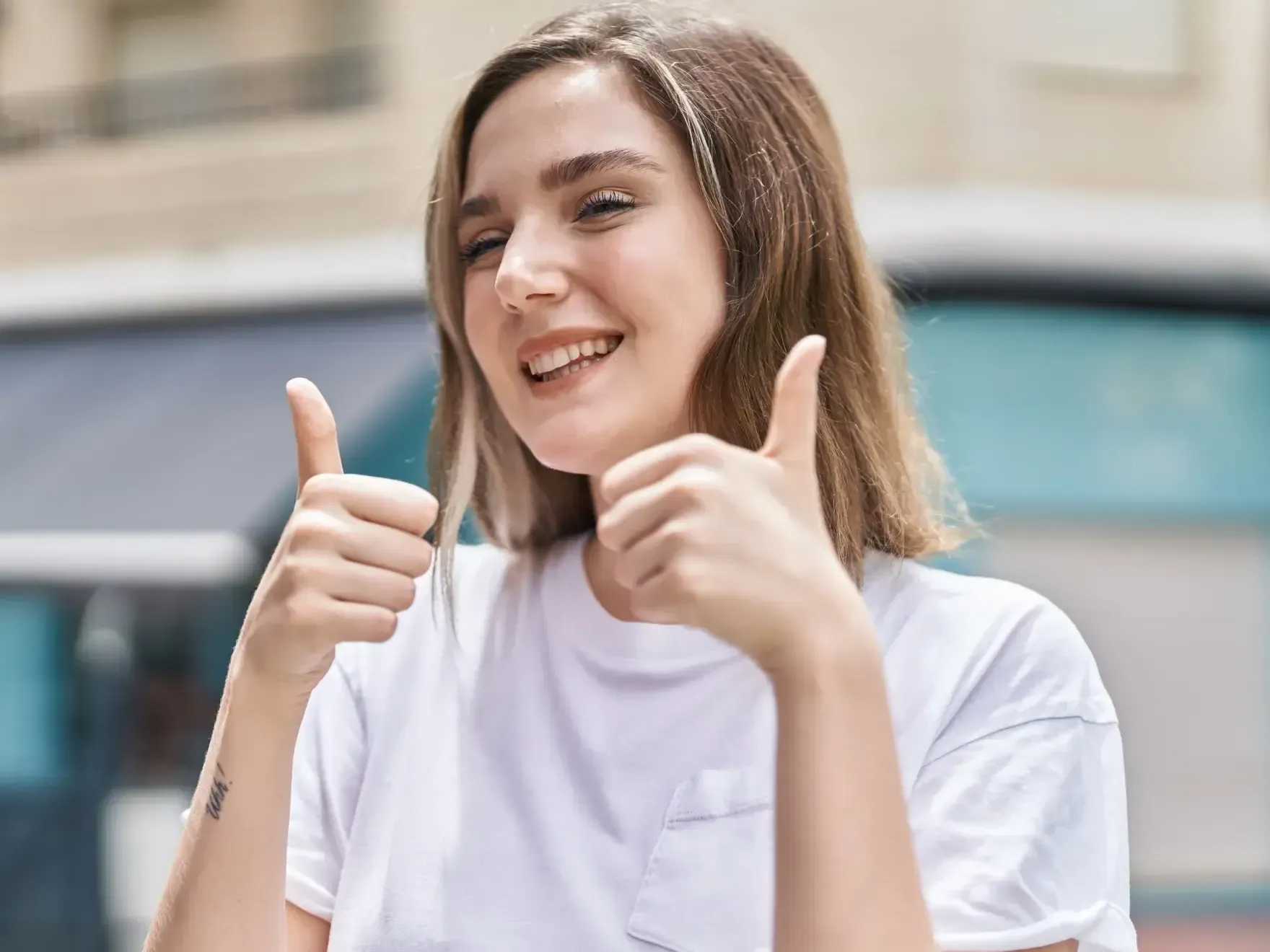 Woman smiling making a thumbs up